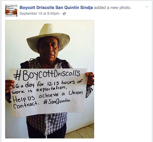 Screenshot of posed portrait of a man holding a sign